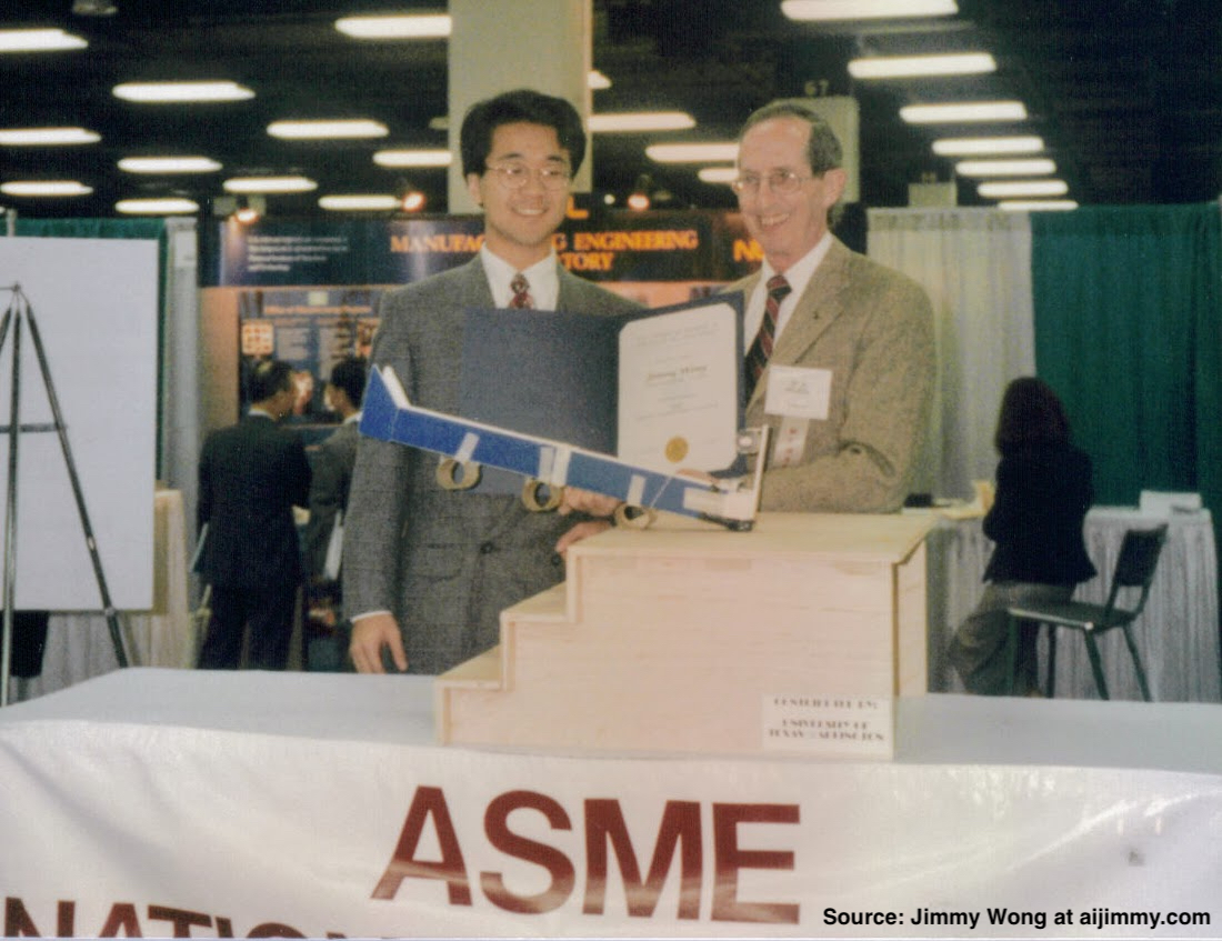 Author and another man standing by an ASME table holding a an award certificate